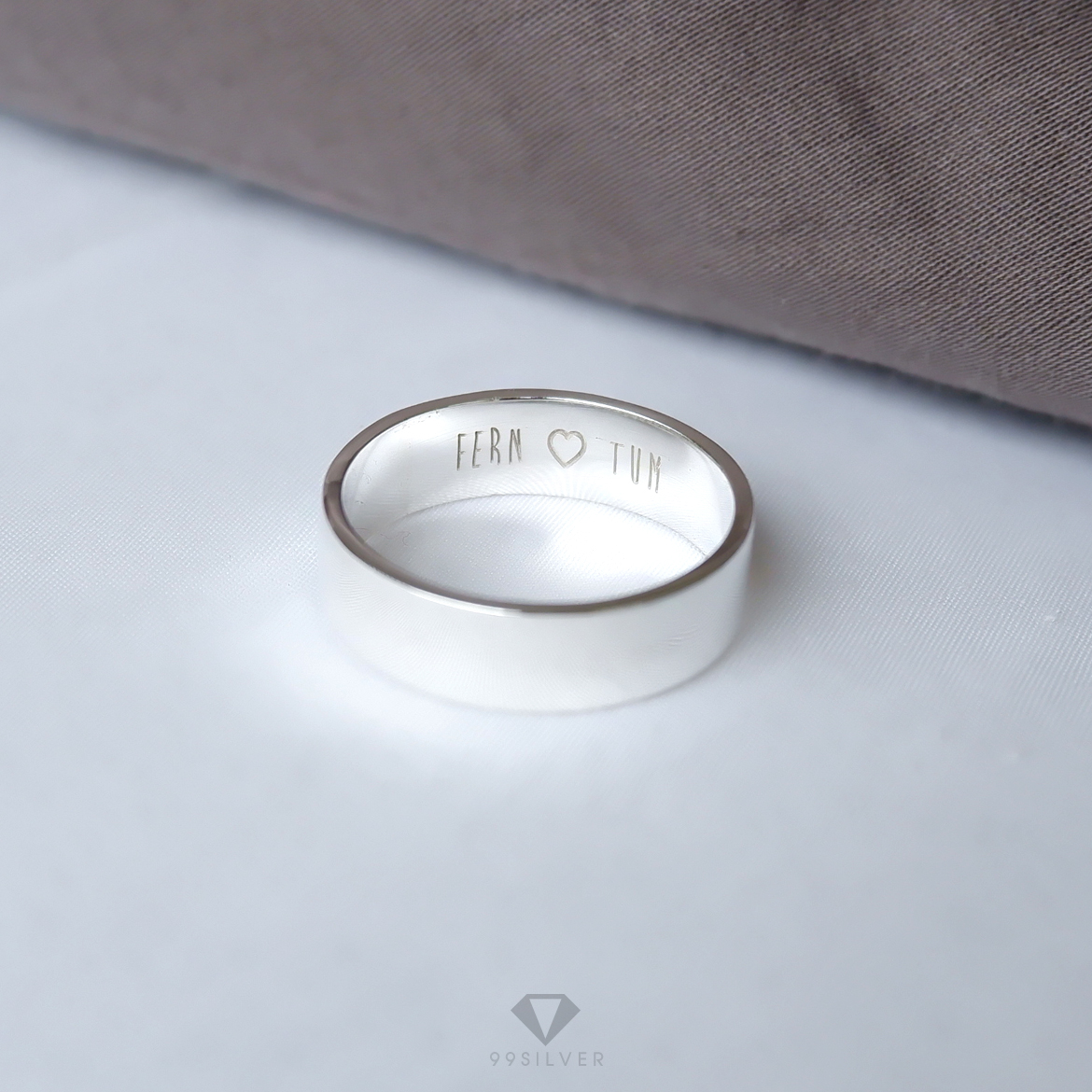 แหวนเงินแท้ หน้ากว้าง 6 มิลลิเมตร ผิวเรียบเงาทรงแบน สลักอักษรสีขาวพ่นทราย